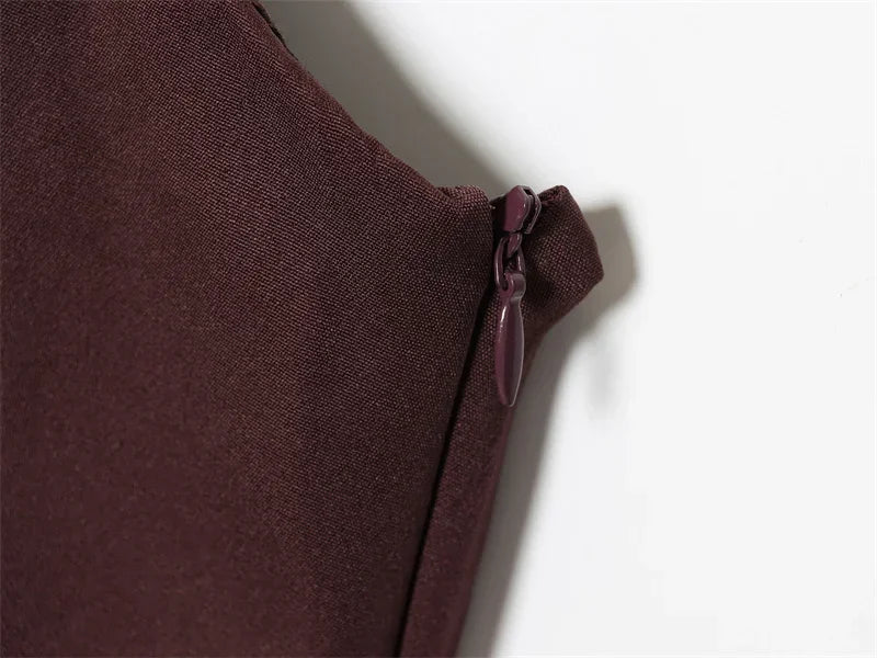 Dark brown fabric with zipper detail, close-up texture shot