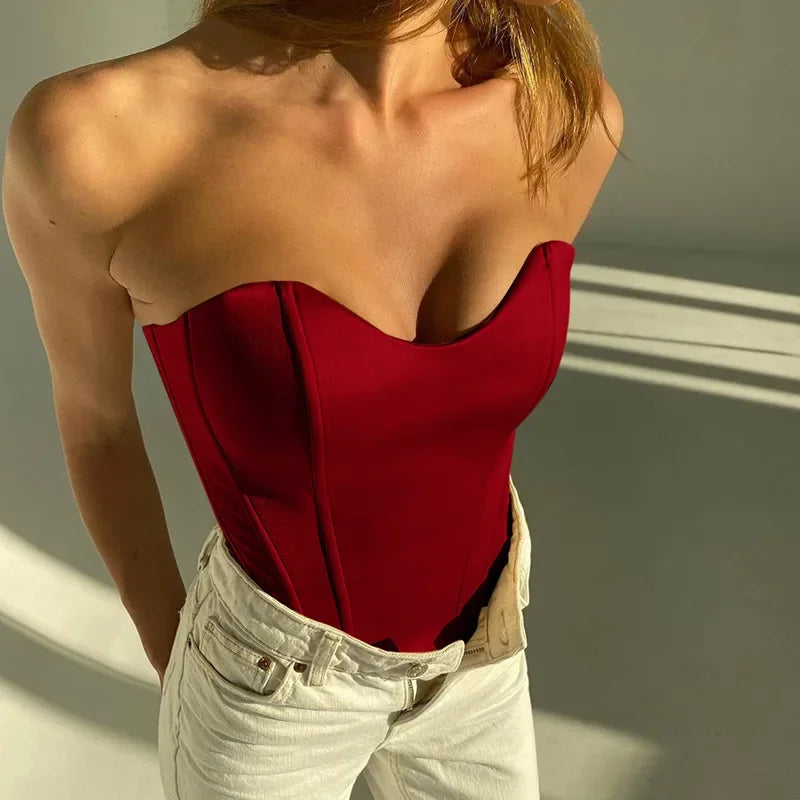Red strapless corset top with sweetheart neckline paired with white jeans, stylish women's fashion